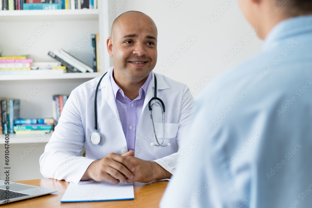 Junger Arzt spricht mit einem Patienten Junger Arzt spricht mit einem Patienten