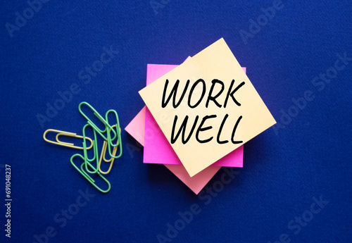Work Well symbol. Orange steaky note with words Work Well. Beautiful deep blue background. Business and Work Well concept. Copy space photo