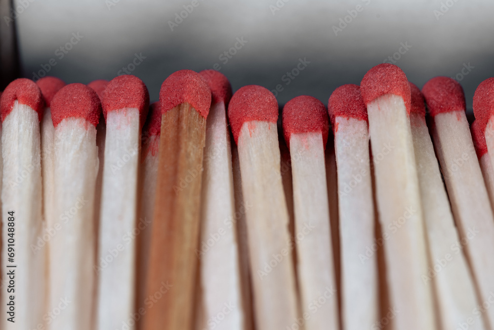 Lots of wooden matches with red sulfur heads closeup. Open box of matches. Matches in a cardboard box Lots of wooden matches with red sulfur heads closeup. Open box of matches. Matches in a cardboard box