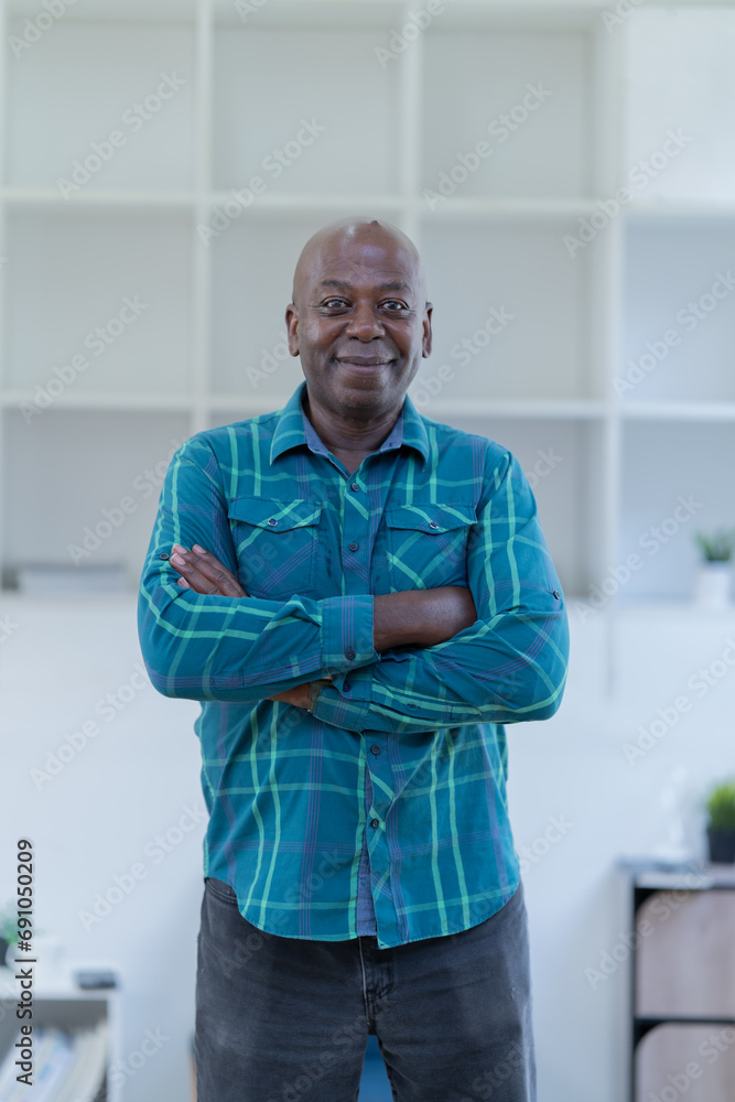 Portrait of happy African American small business owner. Millennial black smiling, sitting and using the laptop, and holding a cup of coffee work in modern office. Portrait of happy African American small business owner. Millennial black smiling, sitting and using the laptop, and holding a cup of coffee work in modern office.