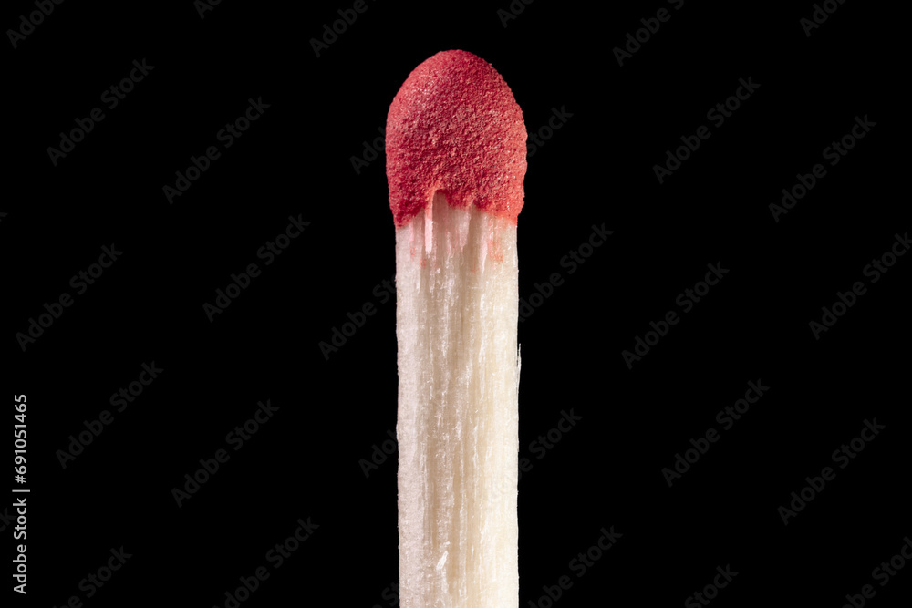 Wooden match with red sulfur head close-up Wooden match with red sulfur head close-up