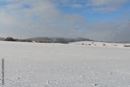 fields and forest in winter germany hessia © Alexander