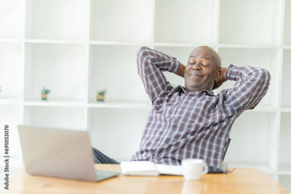 Portrait of happy African American small business owner. Millennial black smiling, sitting and using the laptop, and holding a cup of coffee work in modern office. Portrait of happy African American small business owner. Millennial black smiling, sitting and using the laptop, and holding a cup of coffee work in modern office.