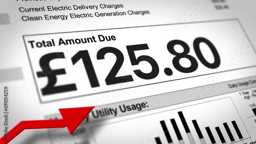 A close-up view of a UK household electric utility bill rising. Increased cost of living concept. British pound sterling version.  	 photo