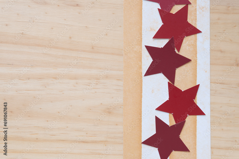 red paper stars on paper with stripes on wood red paper stars on paper with stripes on wood