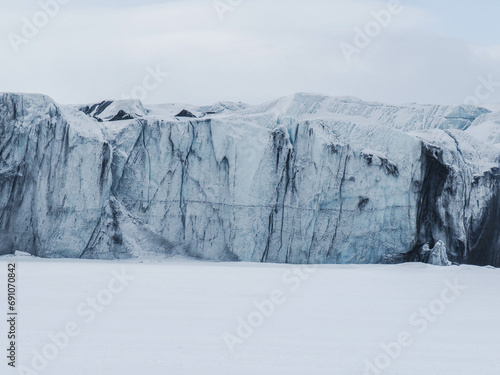 Glacier front with old blue and dirty black ice