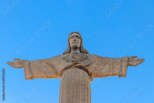 The Sanctuary of Christ the King (Cristo Rei) overlooking the city of Lisbon situated in Almada, in Portugal photo