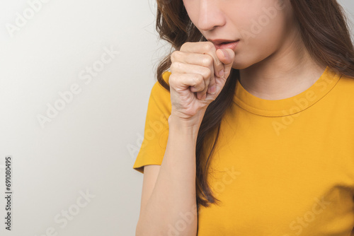 Female unhealthy Sickness, asian young woman, girl unwell and coughing, have cold, sore throat isolated white background suffering with symptom cough feeling bad. Healthcare of Coronavirus, covid-19. photo