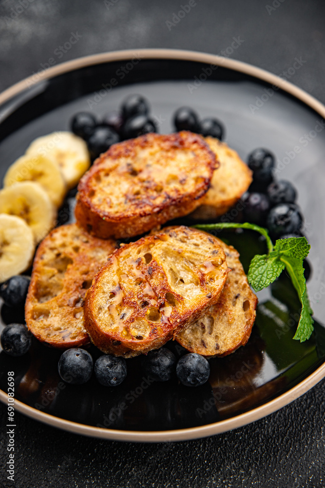 sweet breakfast French toast berrie, banana pancake fresh cooking meal food snack on the table copy space food background rustic top view