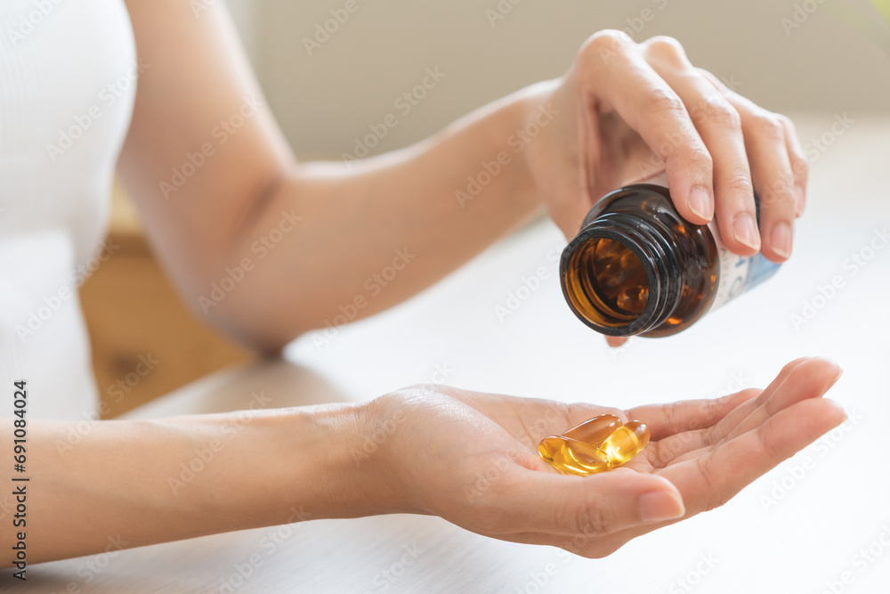 Dietary supplement or sick, asian young woman, girl hold pills, drugs medical tablet on hand pouring capsules from medication bottle, take vitamin for treatment for skin, hair at home, healthcare.