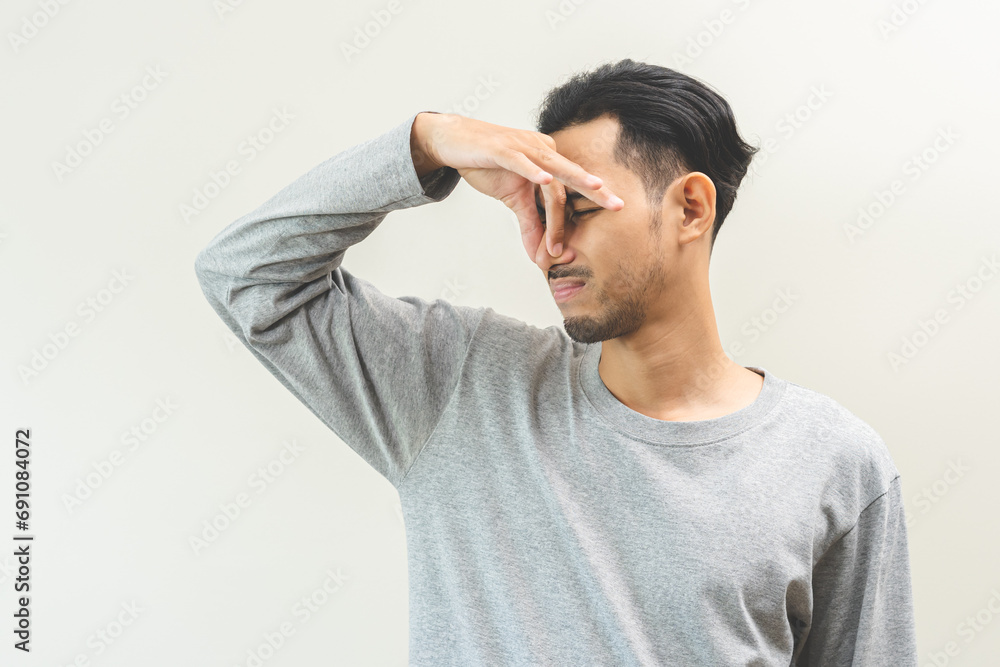 Bad smelling, deodorant asian young man hand squeeze, covering nose smell stink, breathing smelly disgust strong, expression face dislike odor, smelly armpit underarm. Medical health, skin body care. Bad smelling, deodorant asian young man hand squeeze, covering nose smell stink, breathing smelly disgust strong, expression face dislike odor, smelly armpit underarm. Medical health, skin body care.