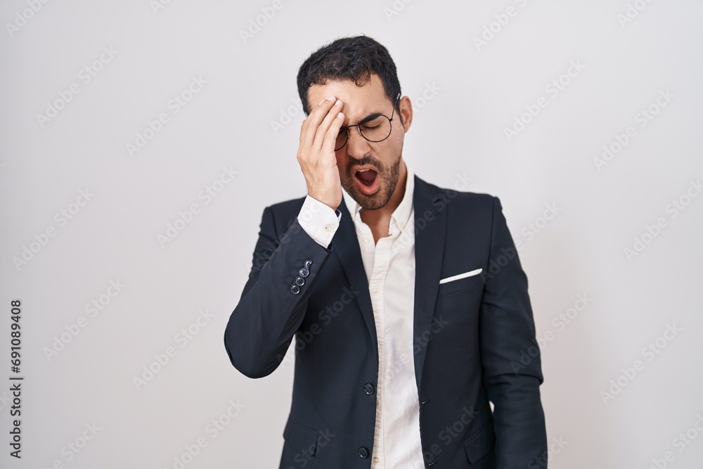 Handsome business hispanic man standing over white background yawning tired covering half face, eye and mouth with hand. face hurts in pain. Handsome business hispanic man standing over white background yawning tired covering half face, eye and mouth with hand. face hurts in pain.