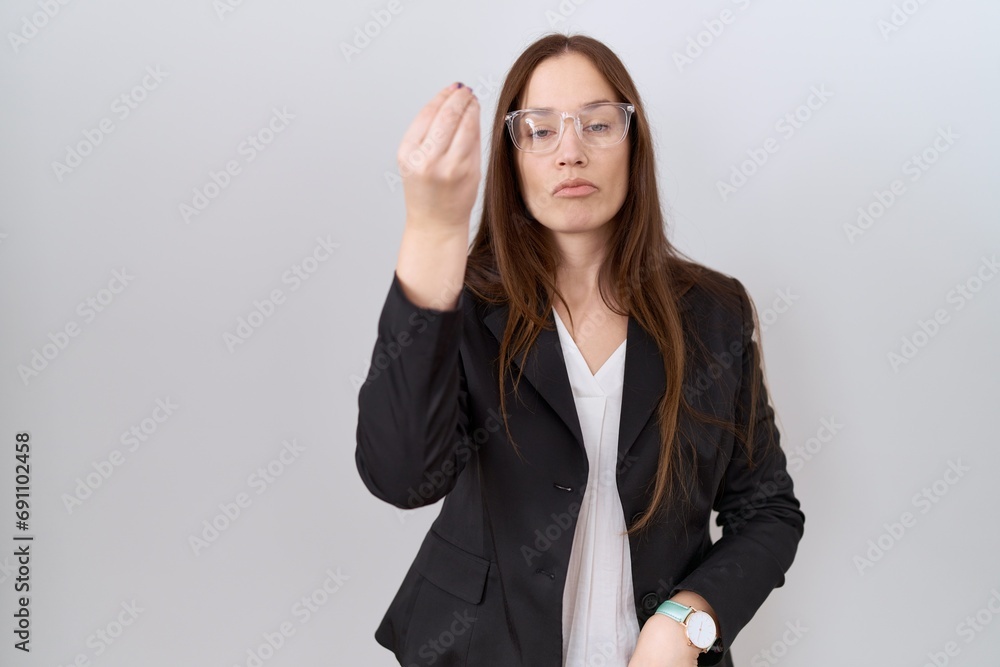 Beautiful brunette woman wearing business jacket and glasses doing italian gesture with hand and fingers confident expression Beautiful brunette woman wearing business jacket and glasses doing italian gesture with hand and fingers confident expression