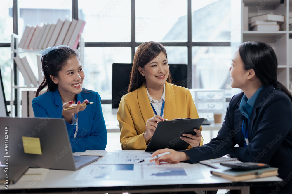 Team of young Asian businesswomen plan and meeting together and present marketing ideas in the office. Team of young Asian businesswomen plan and meeting together and present marketing ideas in the office.