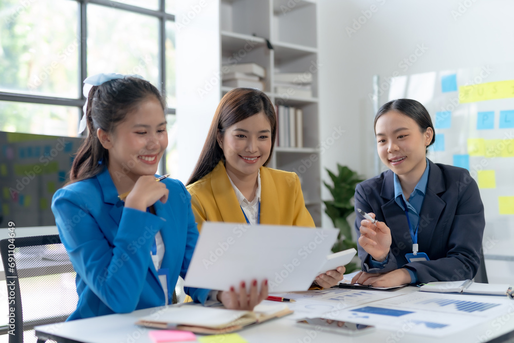 Team of young Asian businesswomen plan and meeting together and present marketing ideas in the office. Team of young Asian businesswomen plan and meeting together and present marketing ideas in the office.