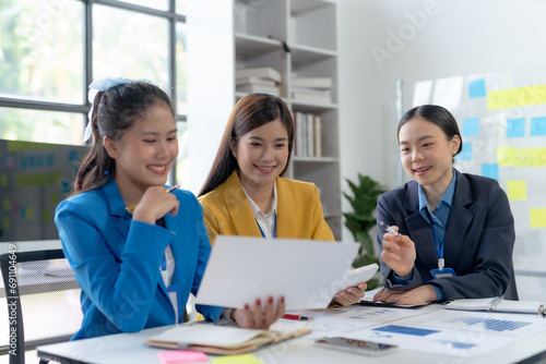 Team of young Asian businesswomen plan and meeting together and present marketing ideas in the office.