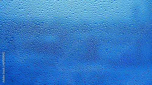 Condensation on window glass in frosty winter weather. Background in the form of small drops on the glass