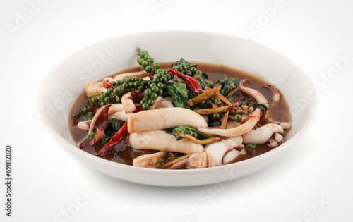 Seafood Padcha a Thai stir frying dish cooked with several herbs  isolated on white background with clipping path, Thai Spicy stir fried squid with raw ingredients scattered around (Pad Cha).