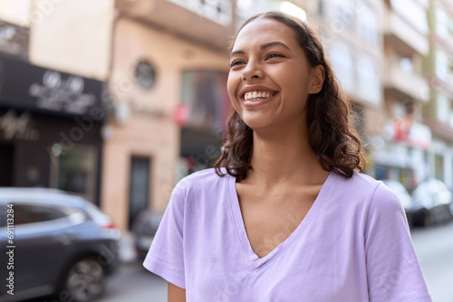 Young african american woman smiling confident looking to the side at street