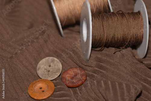 buttons and decorative thread on fabric. photo