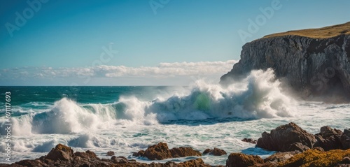  a large body of water with waves crashing against a rocky outcropping with a cliff in the background.