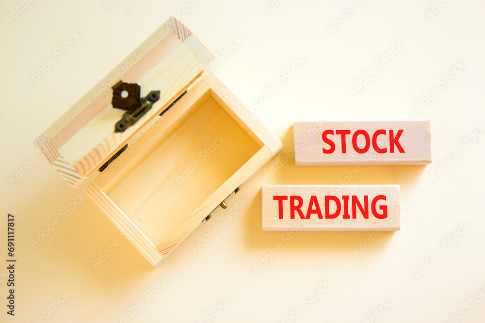 Stock trading symbol. Concept words Stock trading on beautiful wooden blocks. Beautiful white table white background. Empty beautiful wooden chest. Business stock trading concept. Copy space. Stock trading symbol. Concept words Stock trading on beautiful wooden blocks. Beautiful white table white background. Empty beautiful wooden chest. Business stock trading concept. Copy space.