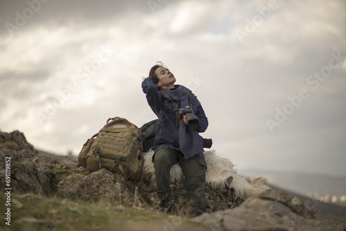 young documentary photographer woman taking photos on mountain trip © Mehtap