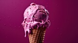  a scoop of ice cream in a waffle cone with pink icing on a purple background with drops of water on the bottom of the cone and on the top of the cone.