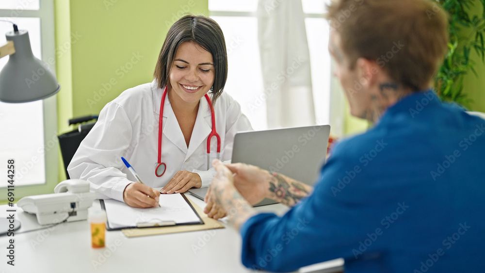 Doctor writing medical report to patient at the clinic Doctor writing medical report to patient at the clinic