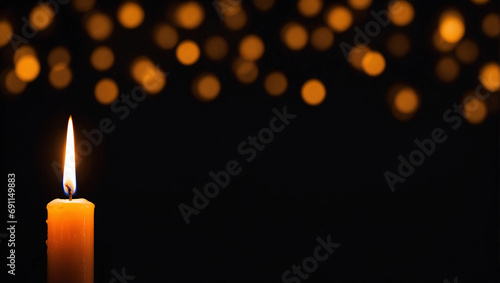 candle on dark black background with bokeh