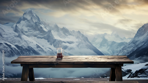 Wooden table with scenic moutains and snow in background. Winter travel adventure in winter.