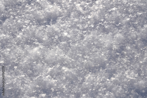 White snow, close-up, large ice crystals, snow-white perfect snowflakes lying on the ground