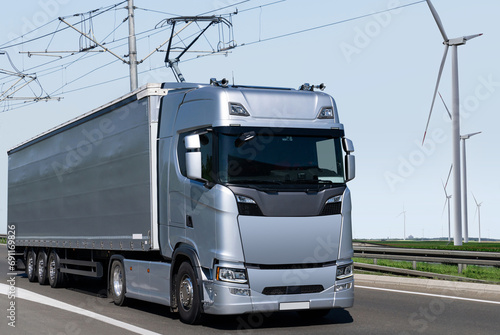 Electric semi truck with pantograph takes energy from wires above the highway