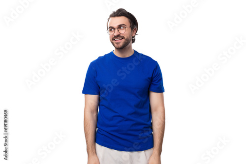 young well-groomed brunette man with a beard in a t-shirt with a brand mockup