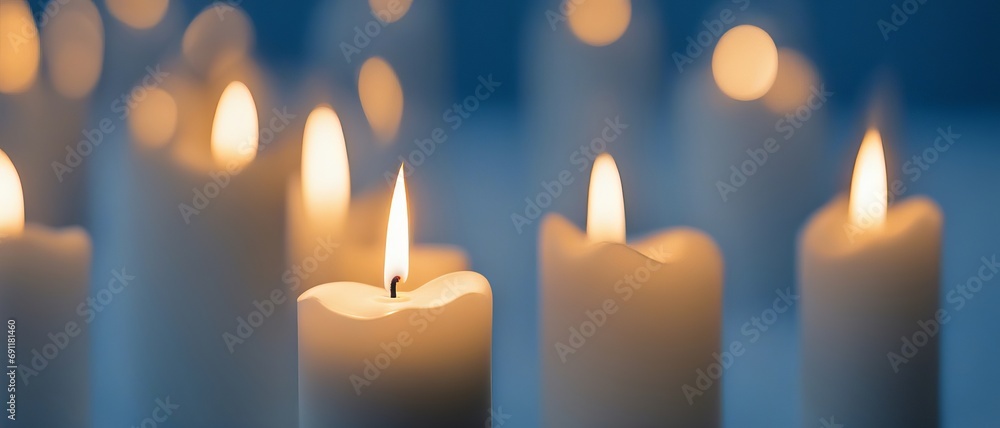 Burning candles close-up on a blue background Burning candles close-up on a blue background