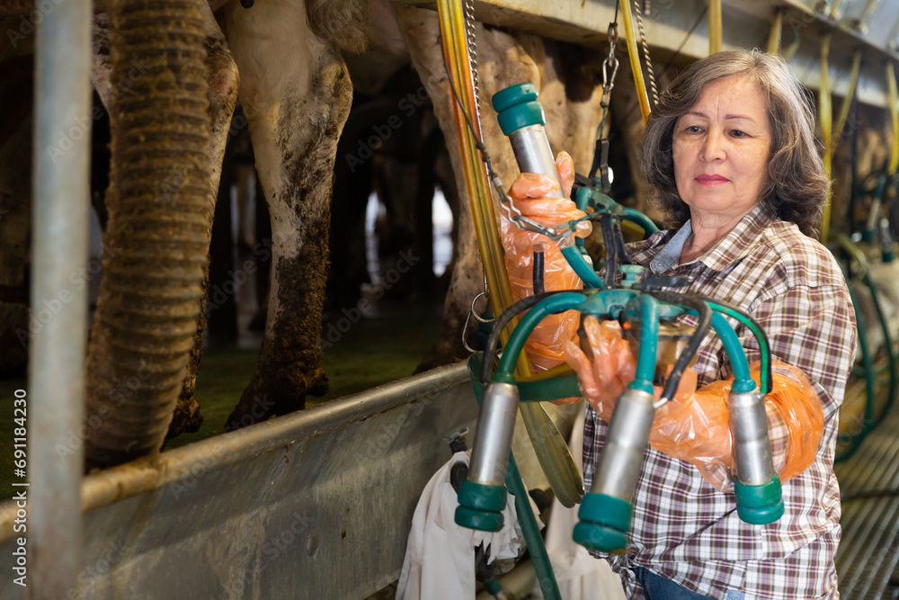 Mature woman going to milk cows at farm