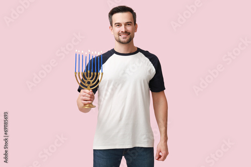 Smiling man holding a lit m...
