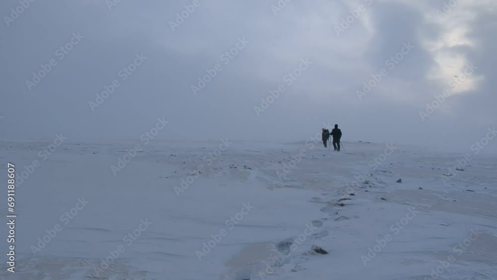 Hikers Climbing Breinosa Mountain in Svalbard Hikers Climbing Breinosa Mountain in Svalbard