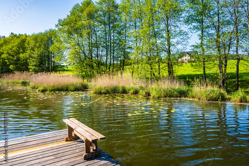 Wooden pier for fishing boats at small lake in Suwalski Landscape Park, Podlasie, Poland photo