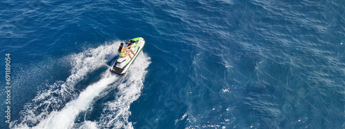 Aerial drone ultra wide panoramic photo with copy space of watercraft with couple cruising in low speed in Caribbean tropical crystal clear waters