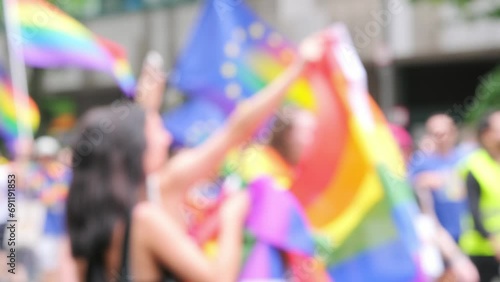 blurred march LGBTQ community, mass march of lesbian, gay people, bisexual, transgender with rainbow flags, Gay pride parade in city with rainbow flags, against discrimination on queer people photo