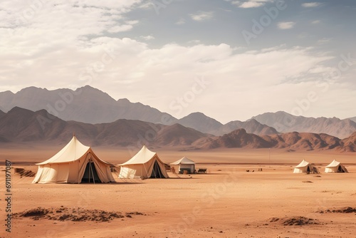 camping tents in the middle of the desert with the mountains at back