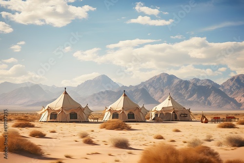 camping tents in the middle of the desert with the mountains at back photo