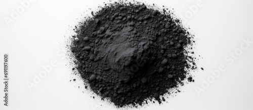 Black charcoal particles isolated on a white background top view Activated charcoal powder. Copy space image. Place for adding text