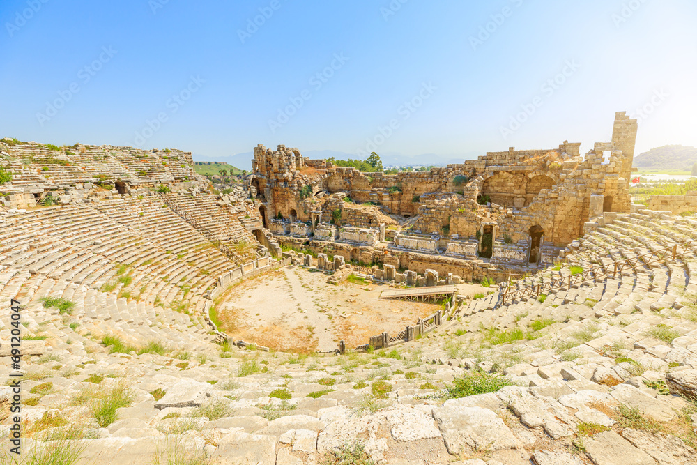 ancient Roman Theatre in Perge, Turkey, a 2nd-century AD architectural wonder. Its well-preserved structure, visible in aerial view, reflects the advanced construction techniques of the Roman era.