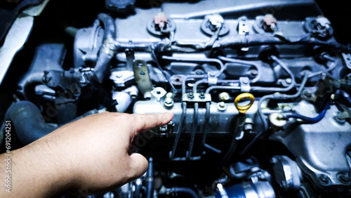 hand pointing at car engine