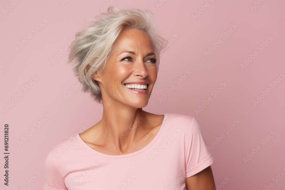 Portrait of a happy senior woman with short white hair over pink background Portrait of a happy senior woman with short white hair over pink background