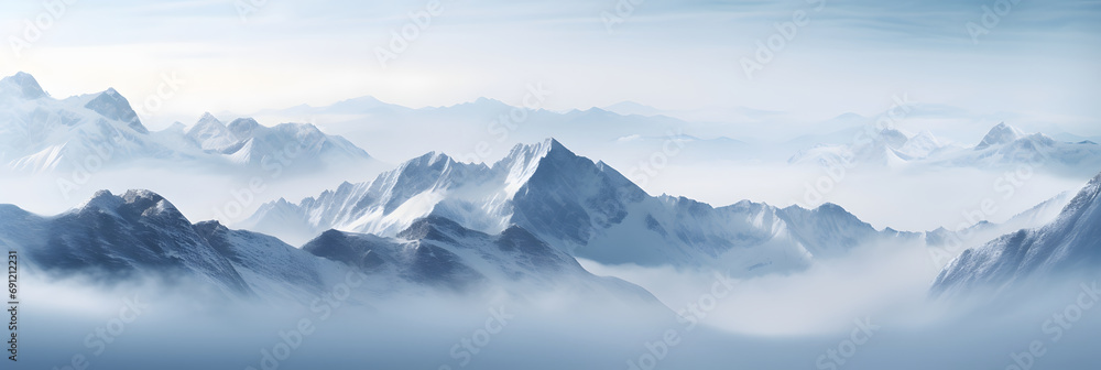 a panoramic view of snowy mountains with snow covered peaks covered with fog and snow in winters - obrazy, fototapety, plakaty 
