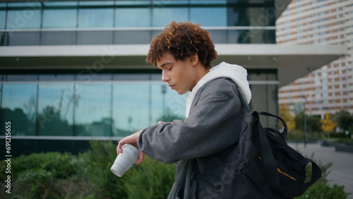 Photos Busy guy checking time at street closeup