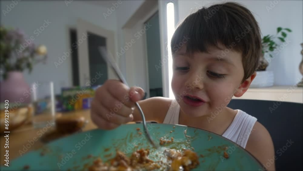 Happy Kid at Lunch time Young Boy Eating with Fork, enjoying meal Happy Kid at Lunch time Young Boy Eating with Fork, enjoying meal